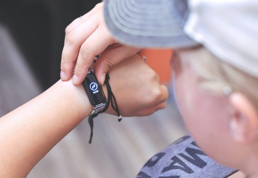 Woman Checking Her Daily Steps on a Fitness Tracking Bracelet